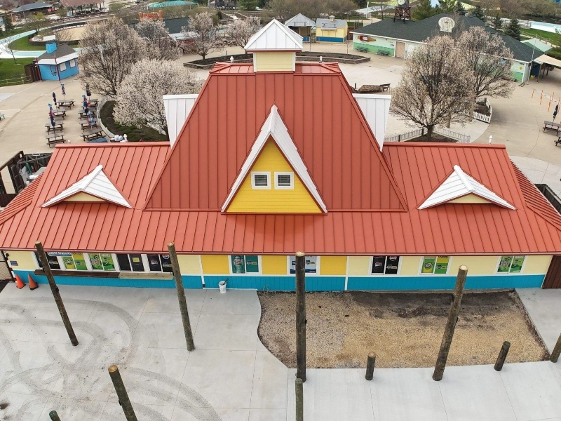 Red standing seam metal roof installed on a commercial building in Yorkville, Illinois