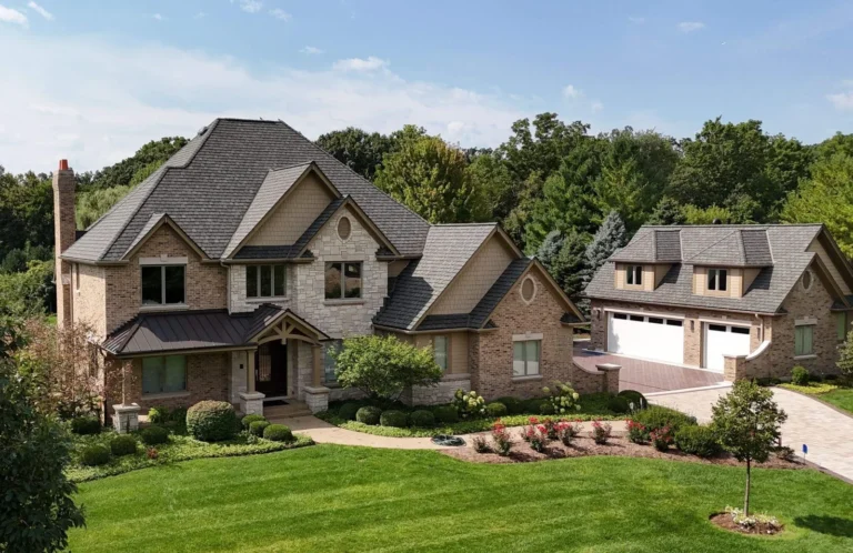 Two-story brick and stone home and detached garage with a new slate roof and standing seam metal porch roof in St. Charles, IL