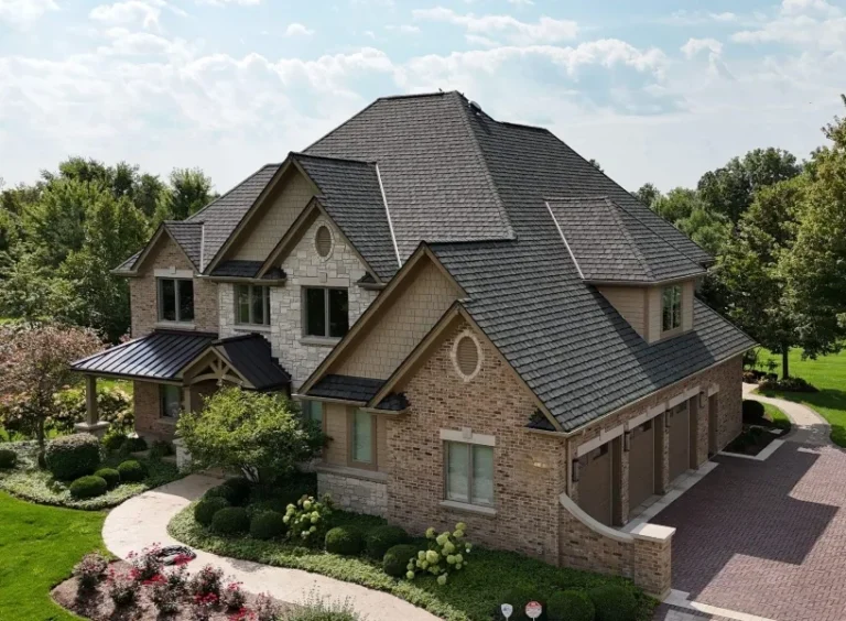 Two-story brick and stone home and detached garage with a new slate roof and standing seam metal porch roof in St. Charles, IL